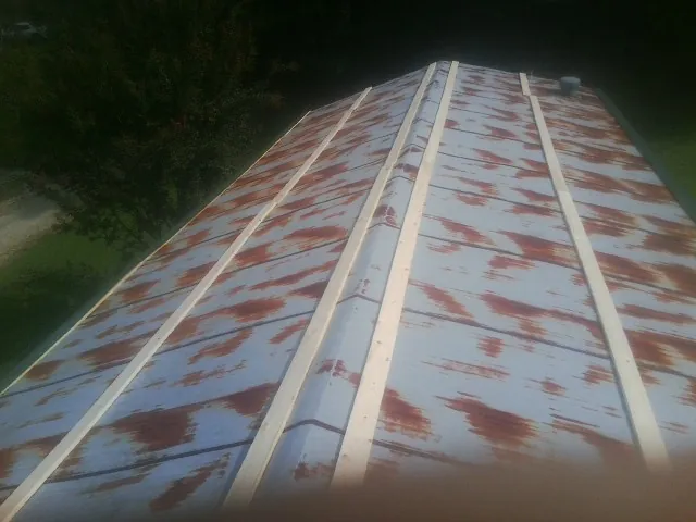 Rusted metal roof panels with new wood purlins before replacement — Storm Damage Roof Repair in La Mesa by Roofing Brothers