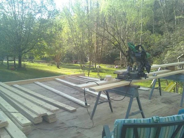 Miter saw and framing lumber on a deck under construction in La Mesa