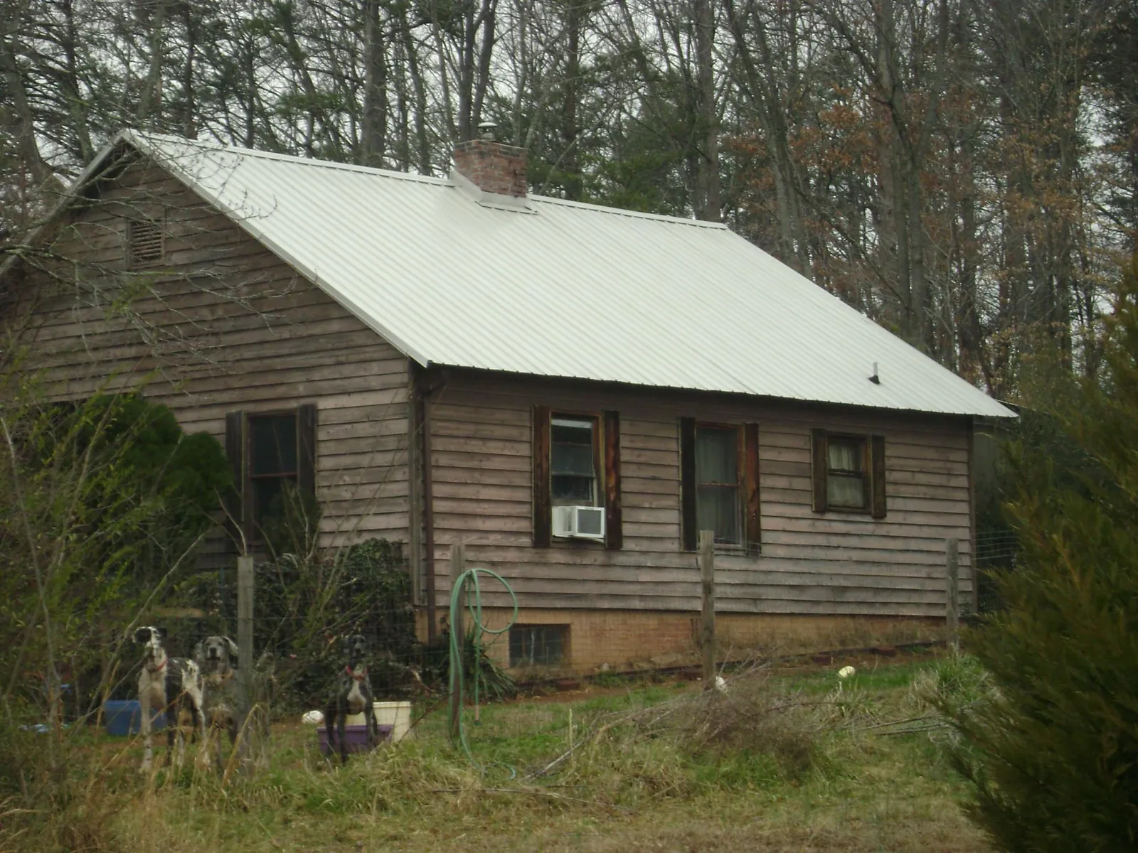 White metal roof on an old wood sided farmhouse, from a Metal Roof Installation job in La Mesa